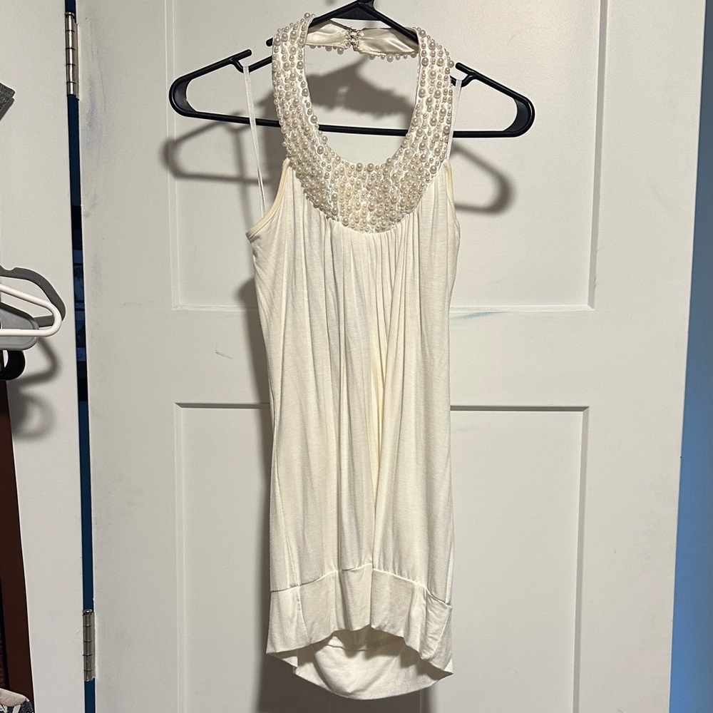 Elegant White Sleeveless Top with Beaded Neckline